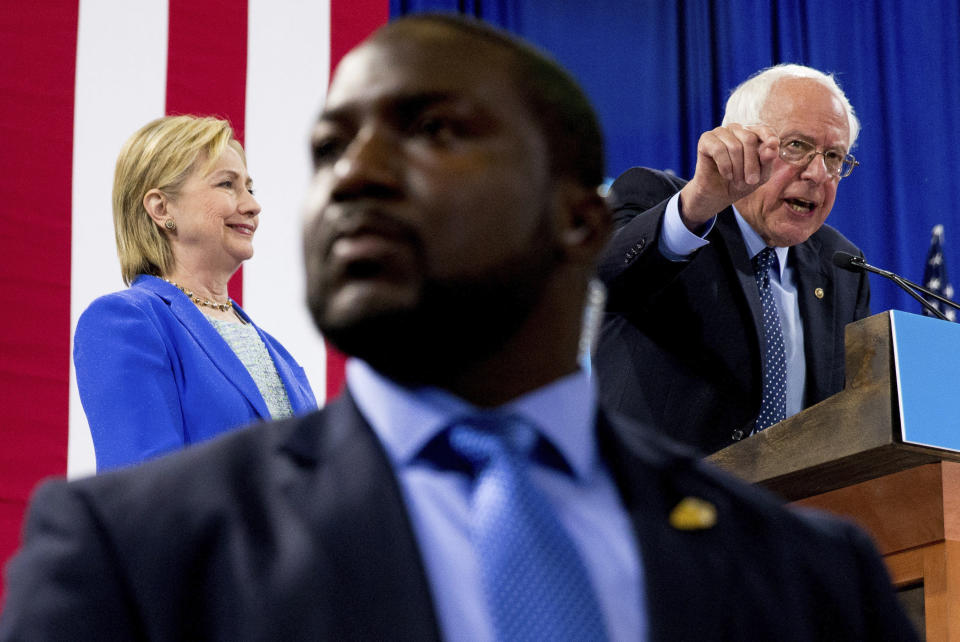 FILE - In this July 12, 2016, file photo, a member of the Secret Service stands guard as Sen. Bernie Sanders, I-Vt., accompanied by Democratic presidential candidate Hillary Clinton, speaks during a rally in Portsmouth, N.H., where Sanders endorsed Clinton for president. (AP Photo/Andrew Harnik, File)