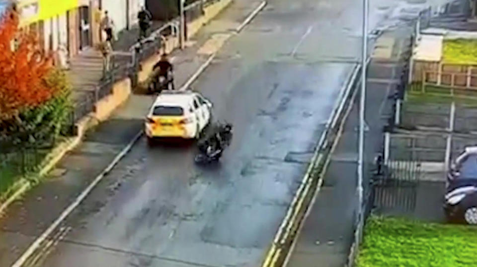 The footage shows the scooter crashing to the ground. (SWNS)