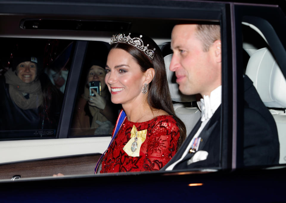 Catherine, Princess of Wales (wearing the Lotus Flower Tiara) and Prince William, Prince of Wales depart after attending the annual Reception for Members of the Diplomatic Corps at Buckingham Palace on December 6, 2022 in London, England. 