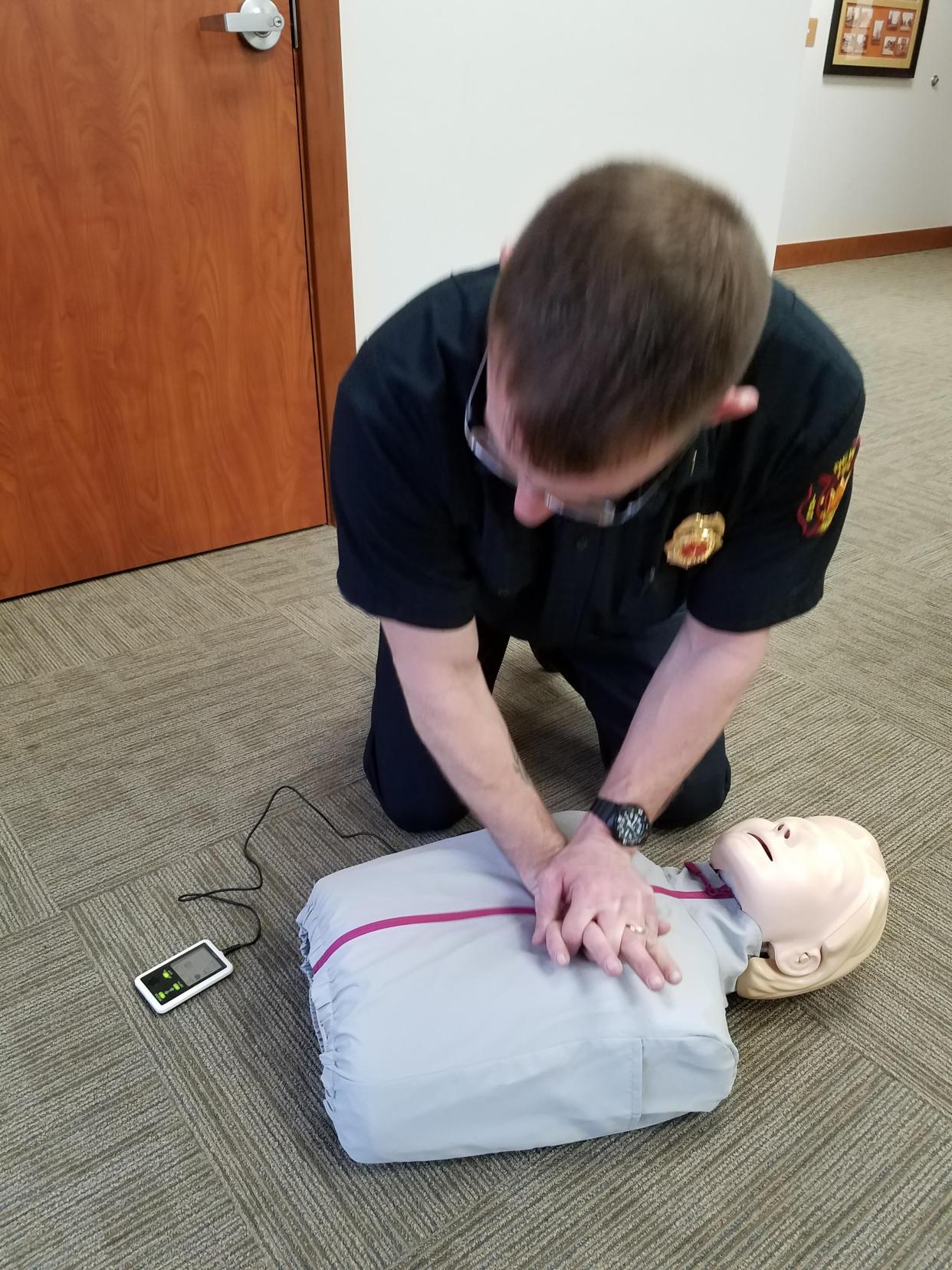 Matthew Graham is shown demonstrating hands-only cardiopulmonary resuscitation in an April 2020 photo, when he was a New Philadelphia Fire Department lieutenant. He was subsequently promoted to captain.