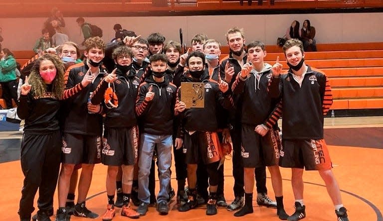 The Aztec Tigers wrestling team stands with the championship award from the 40th annual Tiger Duals, held Saturday, Jan. 22, 2022 at Lillywhite Gym at Aztec High School.