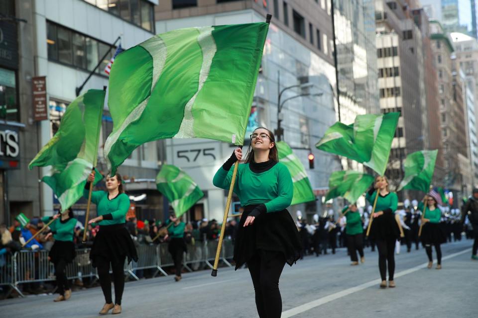 st patricks day activities st patricks day parade with performers holding green flags