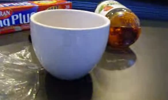Apple cider vinegar, a cup and plastic wrap. That's all you need. Poke small holes into the plastic wrap and watch the lil guys fly in. <a href="https://www.youtube.com/watch?v=IA0DuUdMrRw" target="_blank">Fruit flies just can't resist</a> the smell of vinegar.