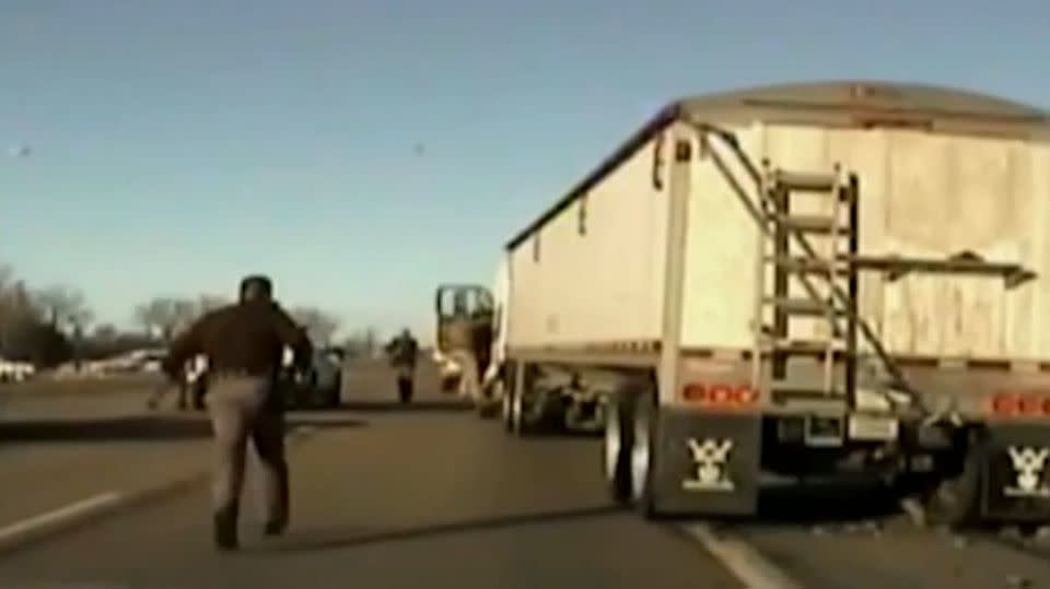 Nebraska officers rush in to help Sergeant Volk and the driver of the semi-trailer. Photo: Dashcam