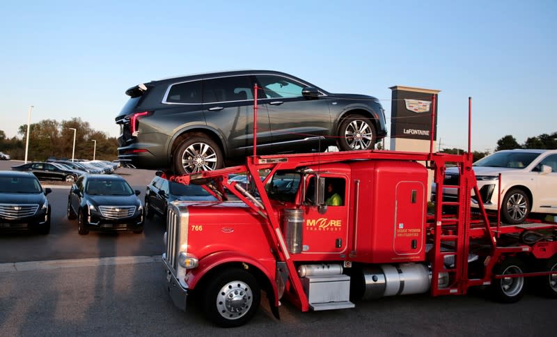 A car hauler delivers two 2020 Cadillac XT6 vehicles to La Fontaine Cadillac dealership in Highland, Michigan,