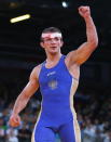 LONDON, ENGLAND - AUGUST 06: Alan Khugaev of Russia celebrates during his Men's Greco-Roman 84 kg Wrestling Semi Final against Vladimer Gegeshidze of Georgia on Day 10 of the London 2012 Olympic Games at ExCeL on August 6, 2012 in London, England. (Photo by Cameron Spencer/Getty Images)