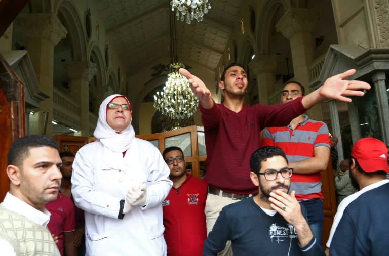 People react at the site of a bomb blast which struck worshippers gathering to celebrate Palm Sunday at the Mar Girgis Coptic Church in the Nile Delta City of Tanta on April 9, 2017