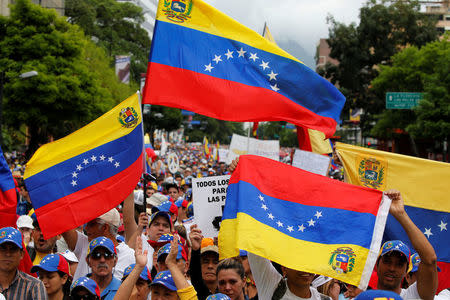 Demonstrators hold Venezuelan flags while rallying against Venezuela's President Nicolas Maduro in Caracas, Venezuela May 1, 2017. REUTERS/Carlos Garcia Rawlins