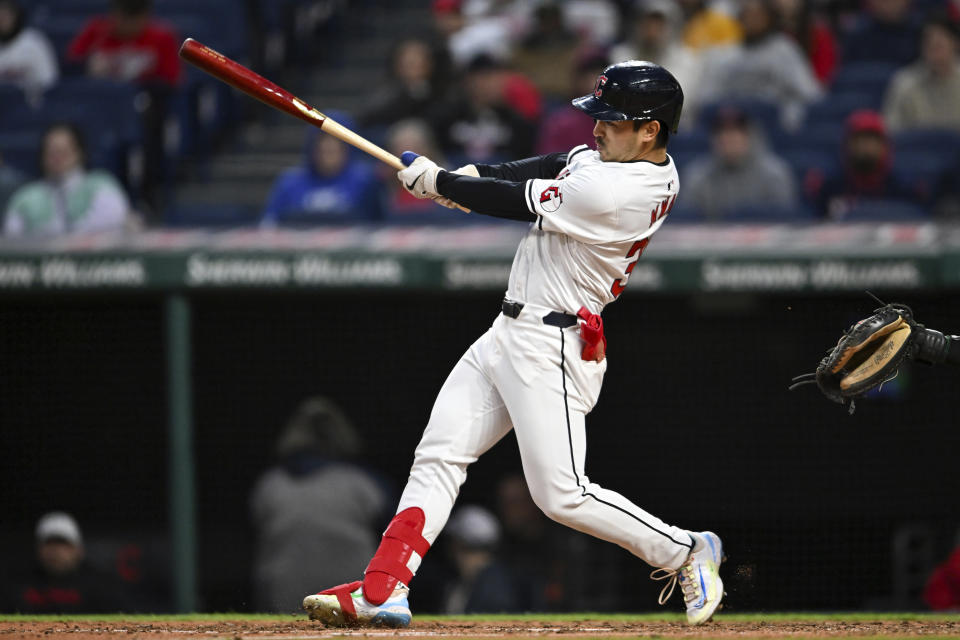 Cleveland Guardians' Steven Kwan follows through on a two-run double against the Oakland Athletics during the fifth inning of a baseball game Friday, April 19, 2024, in Cleveland. (AP Photo/Nick Cammett)