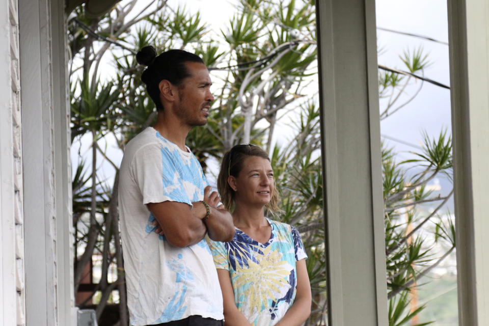 Matt Saunter, left, and Naomi Worcester stand on the porch of their home while under quarantine in Honolulu, Friday, Nov. 6, 2020. Cut off from the rest of the planet since February, Saunter, Worcester and two others are re-emerging from Kure Atoll in the Northwestern Hawaiian Islands, one of the most remote places on Earth, into a society changed by the coronavirus outbreak. Leading the camp on Kure was wildlife biologist Worcester and her partner, Saunter. (AP Photo/Caleb Jones)