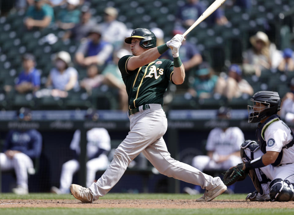 Oakland Athletic's Sean Murphy hits an RBI-double to tie the the baseball game against the Seattle Mariners during the eighth inning, Monday, May 31, 2021, in Seattle. (AP Photo/John Froschauer)