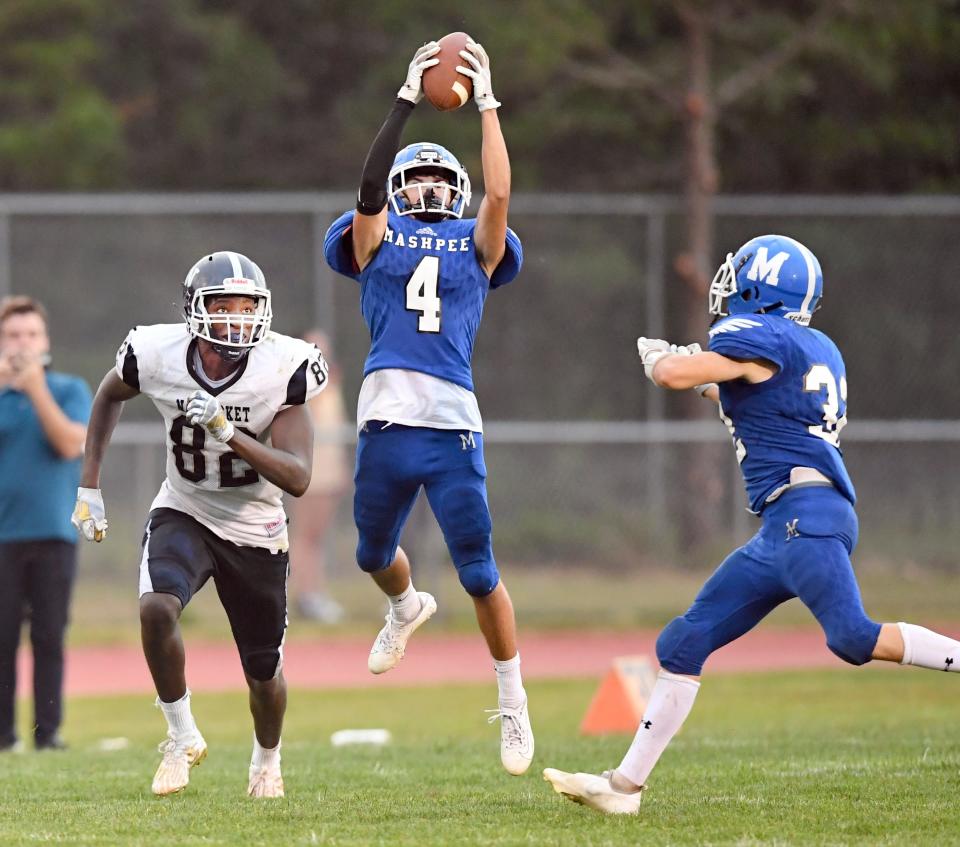 Ethan Costa of Mashpee intercepts a pass meant for Jaron Bennett of Nantucket.