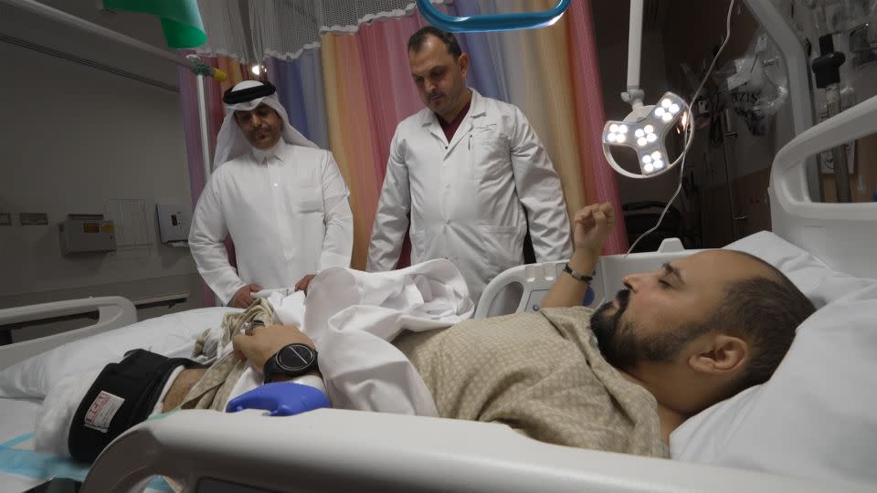 Doctors Hasan Abuhejleh and Ahmed AlSaadi inspect Gaza patients at the Hamad hospital in Doha, Qatar. - Sanjiv Talreja/CNN