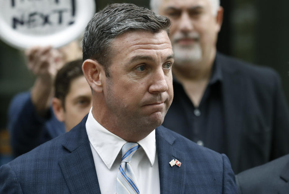 California Republican Rep. Duncan Hunter speaks after leaving federal court Tuesday, Dec. 3, 2019, in San Diego. Hunter gave up his year-long fight against federal corruption charges and pleaded guilty Tuesday to misusing his campaign funds, paving the way for the six-term Republican to step down. (AP Photo/Gregory Bull)