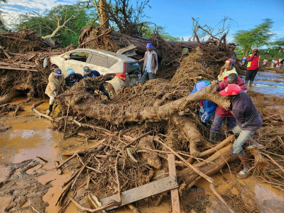 People try to clear the area after a dam burst, in Kamuchiri Village Mai Mahiu, Nakuru County, Kenya (AP)