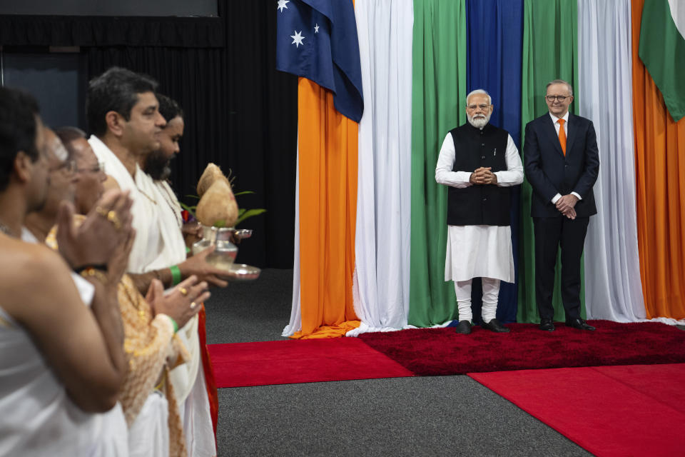 Indian Prime Minister Narendra Modi, second right, and Australian Prime Minster Anthony Albanese, right, are welcomed as they arrive for an Indian community event in Sydney, Tuesday, May 23, 2023. Modi has arrived in Sydney for his second Australian visit as India's prime minister and told local media he wants closer bilateral defense and security ties as China's influence in the Indo-Pacific region grows. (Wolter Peeters/Pool via AP)