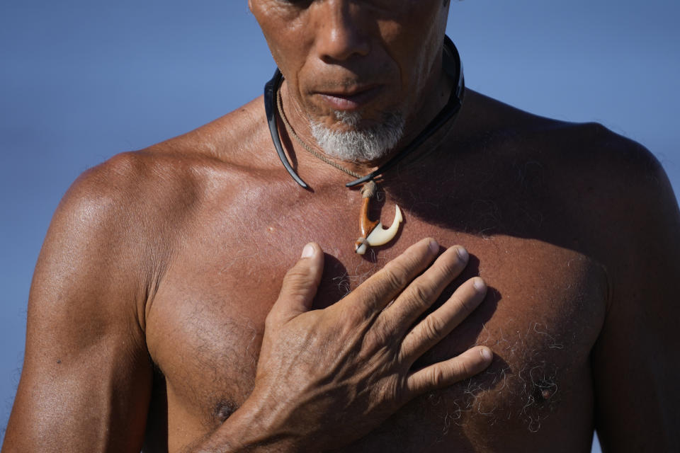 CORRECTS LAST NAME TO RUBIO, NOT RUBOI - Vicente Rubio stands on the shoreline after performing a blessing to greet the day, Tuesday, Aug. 15, 2023, in Kihei, Hawaii, following wildfires that ravaged Maui. (AP Photo/Rick Bowmer)