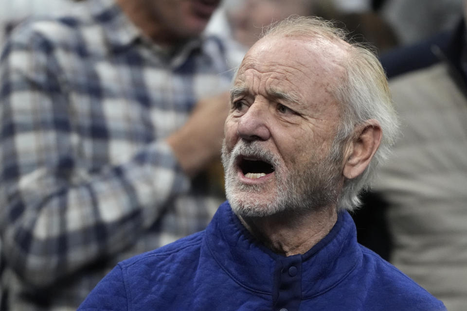 Actor Bill Murray calls from the stands as UConn and Illinois warms up prior to the first half of the Elite 8 college basketball game in the men's NCAA Tournament, Saturday, March 30, 2024, in Boston. (AP Photo/Michael Dwyer)