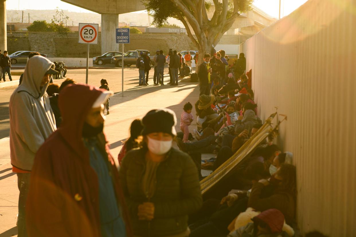 Asylum seekers wait outside the El Chaparral border crossing port to enter the United States from Tijuana in February. 