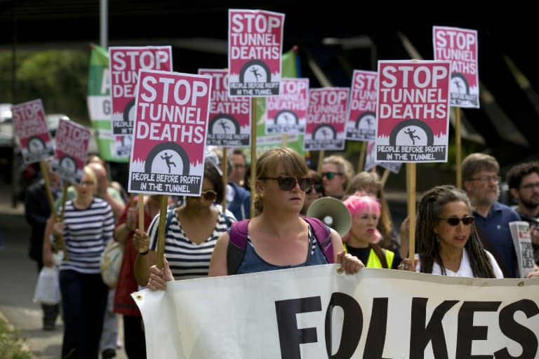 Protesters march at the entrance of the Eurotunnel terminal in Folkestone, southeast England, on August 1, 2015, in support of the migrants trying to cross into England through the channel tunnel from France