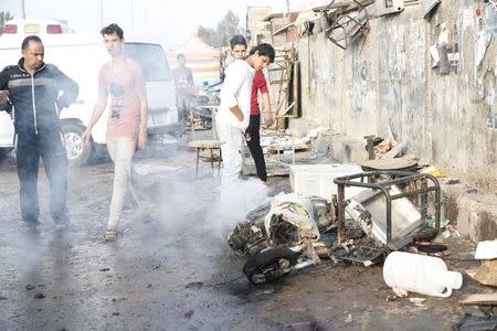 People gather at the site of suicide blasts in Baghdad's Sadr City February 28, 2016. REUTERS/Wissm al-Okili