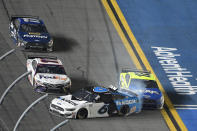 Ryan Newman (6) gets turned into the wall by Ryan Blaney (12) as Denny Hamlin (11) misses them along the front stretch to win the NASCAR Daytona 500 auto race at Daytona International Speedway, Monday, Feb. 17, 2020, in Daytona Beach, Fla. (AP Photo/Phelan M. Ebenhack)