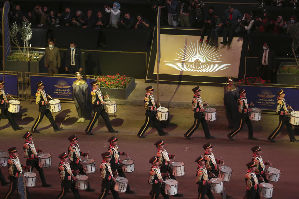 People watch parade of royal mummies in Cairo, Egypt, Saturday, April 3, 2021. Egypt held a parade celebrating the transport of 22 of its prized royal mummies from Egyptian Museum to he newly opened National Museum of Egyptian Civilization. (AP Photo)