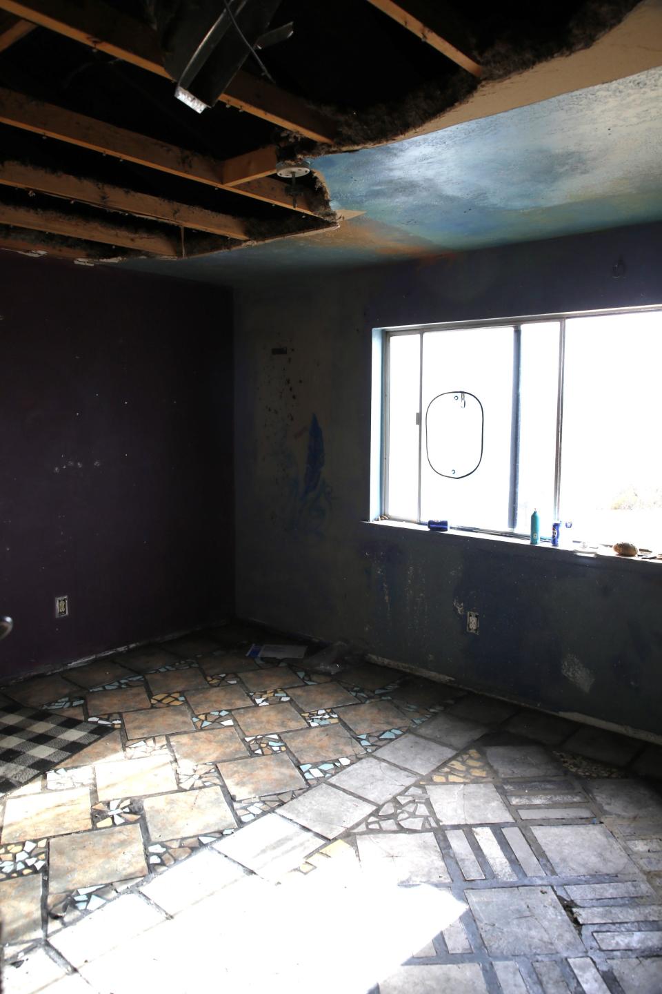 Fire, smoke and water damage is evident in a ground-floor bedroom of the Green family home north of Aztec.