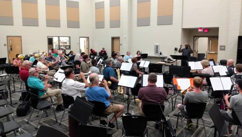 Dr. Paxton Girtmon, conductor, leads members of the Mississippi Community Symphony Band during rehearsals Tuesday at the Northwest Rankin High School band hall.