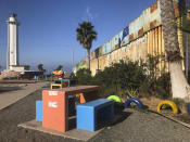 In Tijuana, the Mexican side of a cross-border garden, is located in a popular recreational area on the Pacific Ocean, Saturday, Jan. 25, 2020. The U.S. Border Patrol, reacting to a breach it discovered in a steel-pole border wall believed to be used by smugglers, gave activists no warning this month when it bulldozed the U.S. side of the cross-border garden on an iconic bluff overlooking the Pacific Ocean. On Saturday, after a public apology for "the unintentional destruction," the agency allowed the activists in a highly restricted area to resurrect the garden. (AP Photo/Elliot Spagat)