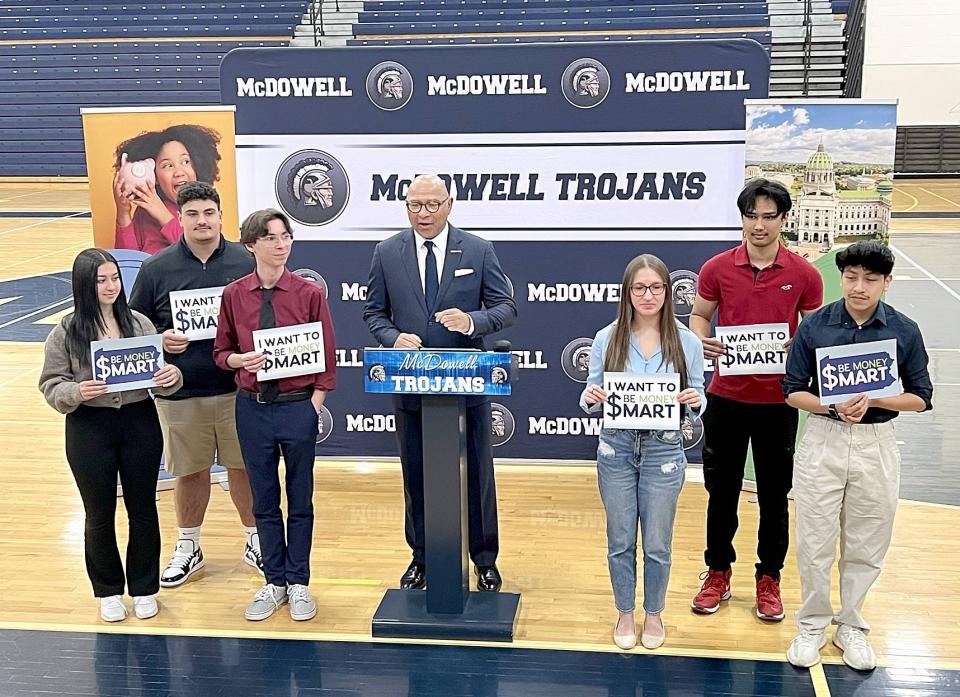 Pennsylvania Auditor General Tim DeFoor, center, spoke about the need for financial literacy in Pennsylvania's schools during a visit to McDowell High School on April 19.