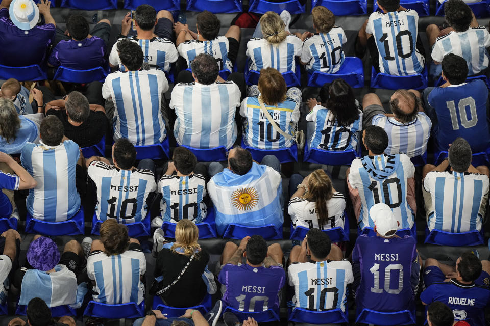 Fans wearing Argentina's Lionel Messi shirts watching the World Cup group C soccer match between Poland and Argentina at the Stadium 974 in Doha, Qatar, Wednesday, Nov. 30, 2022. Argentina won 2-0.(AP Photo/Pavel Golovkin)