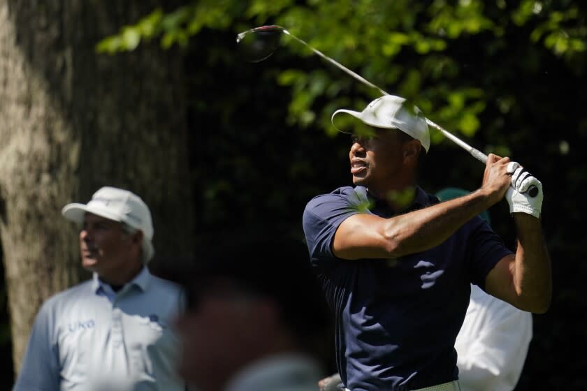 Fred Couples watches as Tiger Woods tees off on the second hole during a practice round for the Masters golf tournament on Monday, April 4, 2022, in Augusta, Ga. (AP Photo/Robert F. Bukaty)