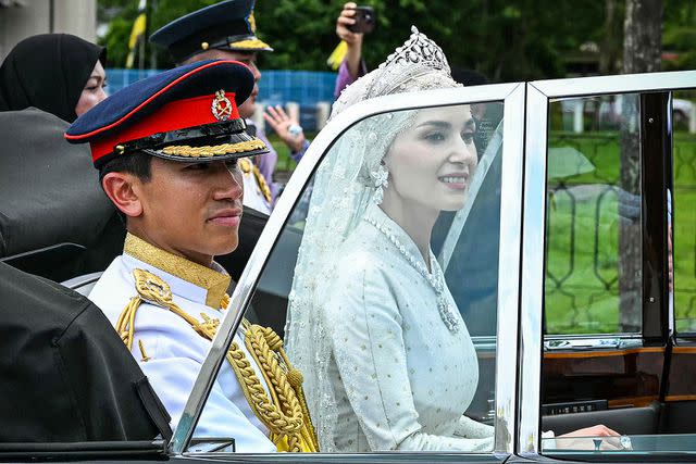 <p>MOHD RASFAN/AFP via Getty</p> Prince Abdul Mateen and Anisha at their wedding ceremony on Jan. 14, 2023