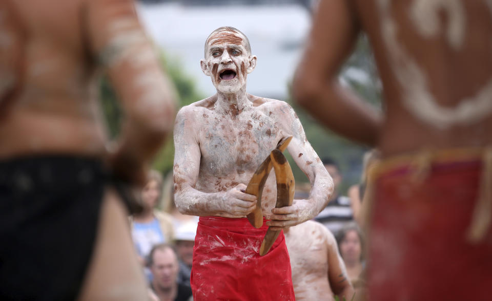 FILE - A member of the Aboriginal community takes part in a traditional smoking ceremony that is performed as part of Australia Day celebration in Sydney, Jan. 26, 2017. Australia’s House of Representatives voted overwhelming on Wednesday, May 31, 2023 in favor of holding a referendum this year on creating a so-called Indigenous Voice to Parliament, an advocate that promises the nation’s most disadvantaged ethnic minority more say on policies that effect their lives. (AP Photo/Rick Rycroft, File)