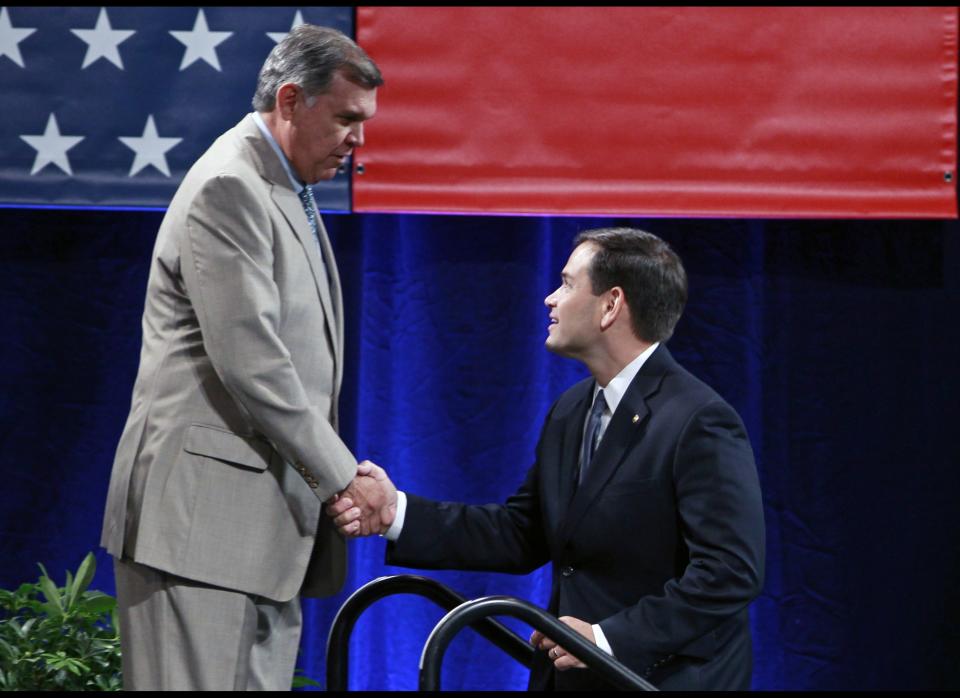 Former Sen. Mel Martinez, left, R-Fla., greets Sen. Marco Rubio, R-Fla., after he introduced him at the NALEO (National Association of Latino Elected and Appointed Officials) conference, Friday, June 22, 2012, in Lake Buena Vista, Fla. (AP Photo/John Raoux)