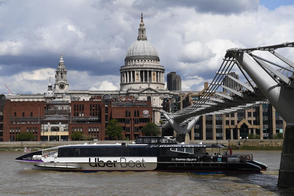 An Uber boat passes St Paul's cathedral in partnership with Thames clippers the boat tickets can be purchased via the ride hailing firm's app on August 3, 2020. (Photo by DANIEL LEAL-OLIVAS / AFP) (Photo by DANIEL LEAL-OLIVAS/AFP via Getty Images)