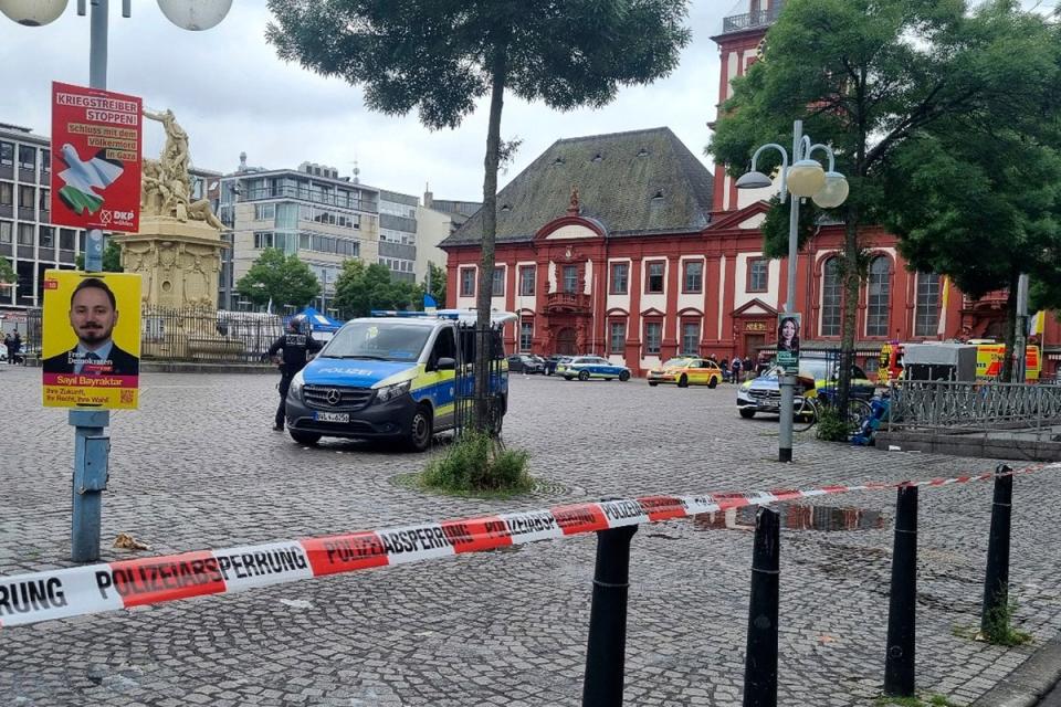The area is cordoned off as police and firefighters are deployed following an incident on Mannheim's market square (AP)