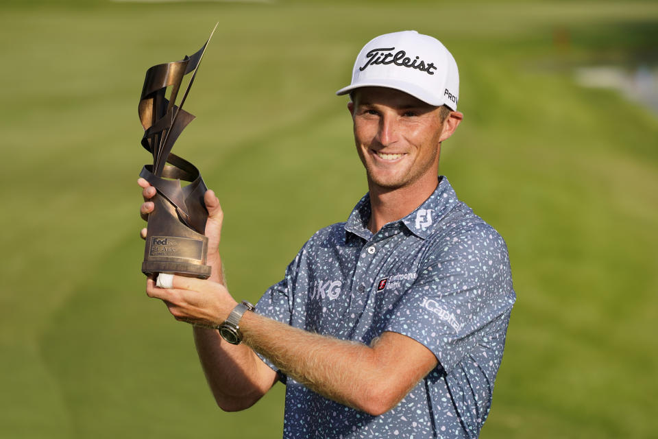 Will Zalatoris holds the trophy after winning the St. Jude Championship golf tournament, Sunday, Aug. 14, 2022, in Memphis, Tenn. (AP Photo/Mark Humphrey)