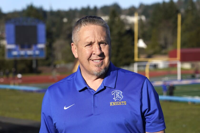 Joe Kennedy, a former assistant football coach at Bremerton High School in Bremerton, Wash., poses for a photo March 9, 2022