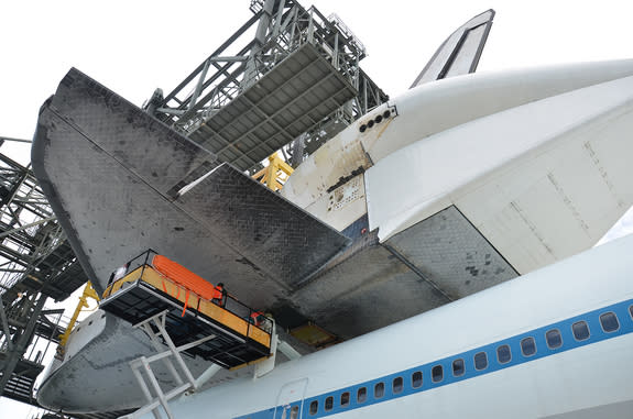 Space shuttle Endeavour is “soft mated” to the Shuttle Carrier Aircraft (SCA) inside the Mate-Demate Device at the Shuttle Landing Facility at NASA's Kennedy Space Center in Florida on Sept. 14, 2012. The operation is the last of its type for t