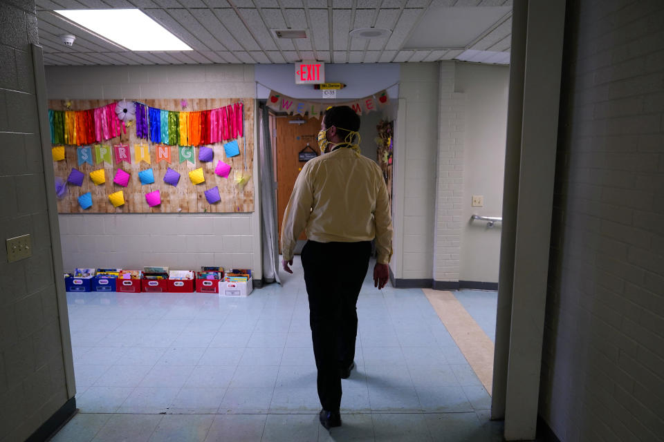Principal Rob Palazzo walks down a hall at Panther Valley Elementary School, Thursday, March 11, 2021, in Nesquehoning, Pa. On May 26, 2020, former student, 9-year-old Ava Lerario; her mother, Ashley Belson, and Ava's father, Marc Lerario, were found fatally shot inside their home. Palazzo says he and the rest of the school and community are grappling with the what-ifs: What if school had been open, and they had a chance to save Ava? (AP Photo/Matt Slocum)