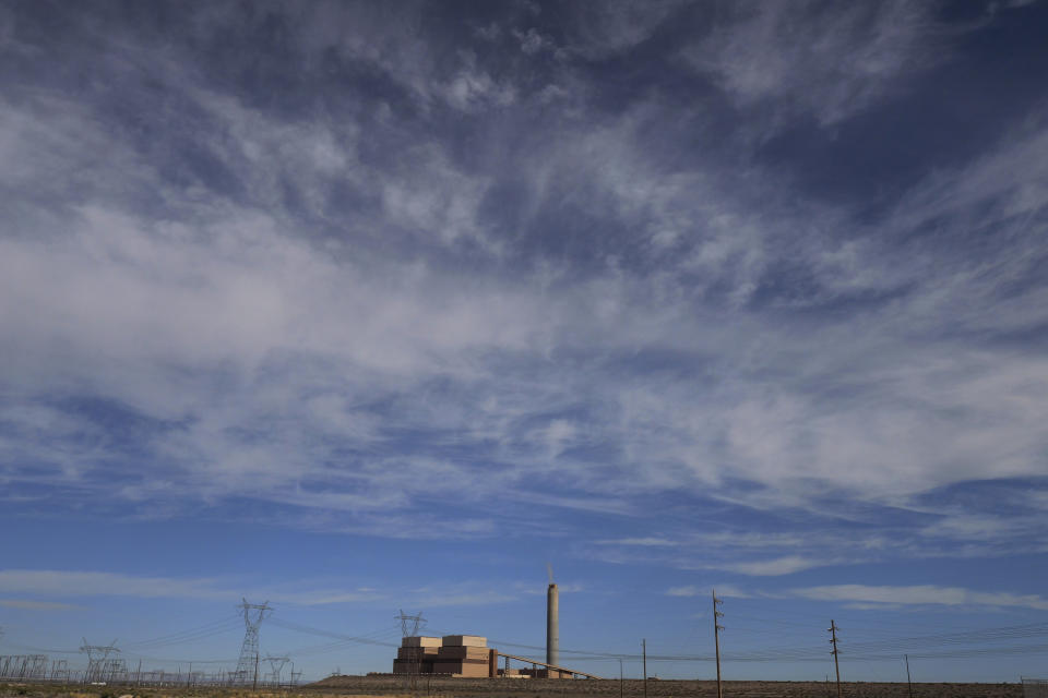A smokestack stands at a coal plant on Wednesday, June 22, 2022, in Delta, Utah. Developers in rural Utah who want to create big underground caverns to store hydrogen fuel won a $504 million loan guarantee this spring. They plan to convert the site of the 40-year-old coal power plant to cleanly-made hydrogen by 2045. (AP Photo/Rick Bowmer)