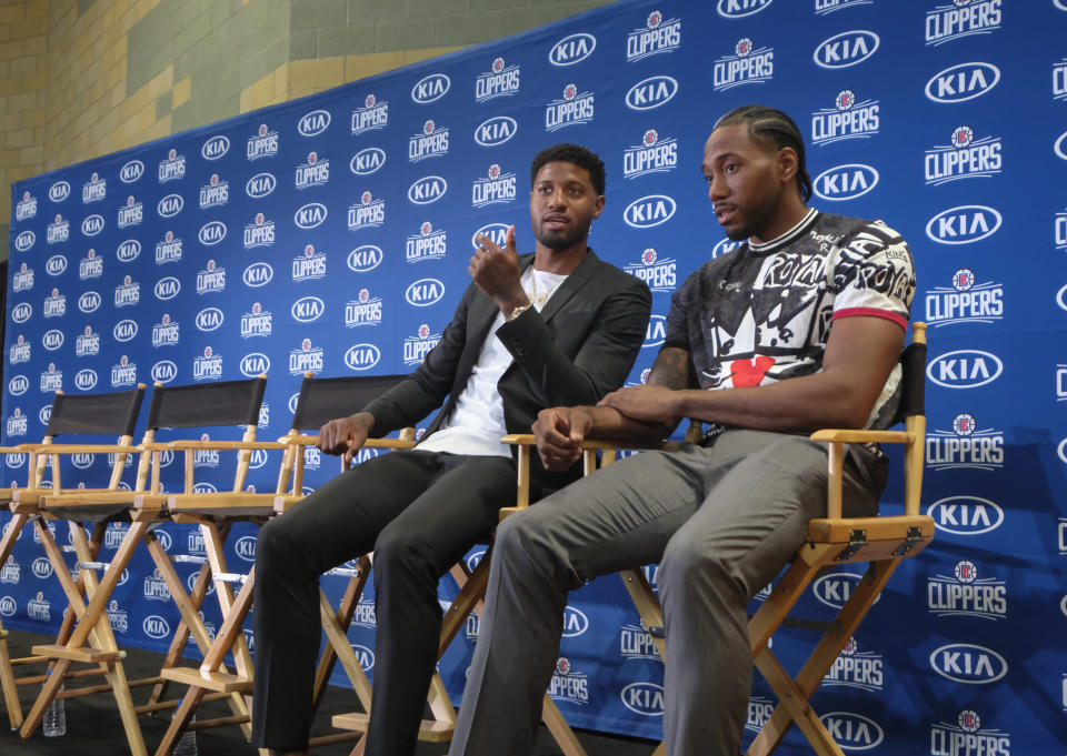 Paul George, left, and Kawhi Leonard attend a press conference in Los Angeles, Wednesday, July 24, 2019. Nearly three weeks after the native Southern California superstars shook up the NBA by teaming up with the Los Angeles Clippers, the dynamic duo makes its first public appearance. (AP Photo/Ringo H.W. Chiu)