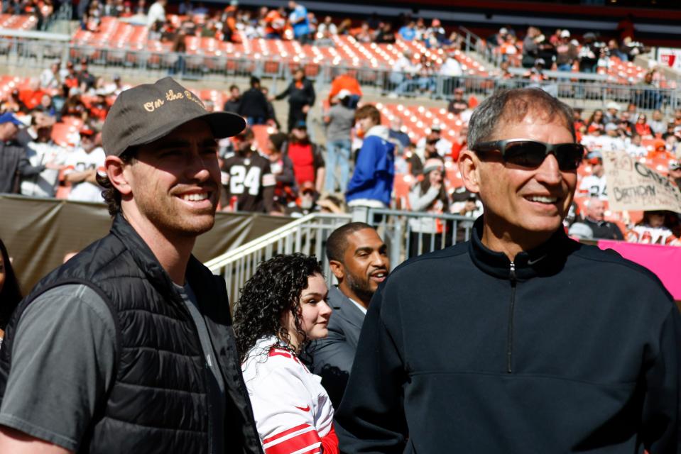Guardians pitcher Shane Bieber, left, stands with former Browns quarterback Bernie Kosar on the sideline as the teams warm up before a game between the Browns and Chargers, Sunday, Oct. 9, 2022, in Cleveland.