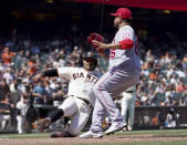 San Francisco Giants' Donovan Solano, left, slides into home plate on a wild pitch by Los Angeles Angels' Jose Quijada, right, during the seventh inning of a baseball game Monday, May 31, 2021, in San Francisco. (AP Photo/Tony Avelar)