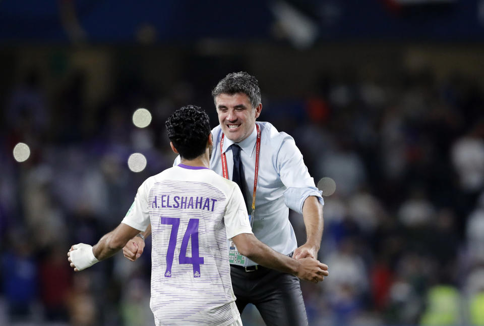 Emirates's Al Ain head coach Zoran Mamic, right, celebrates with Emirates's Al Ain Hussein Elshahat during a penalty shootout at the end of the Club World Cup semifinal soccer match between Al Ain Club and River Plate at the Hazza Bin Zayed stadium in Al Ain, United Arab Emirates, Tuesday, Dec. 18, 2018. (AP Photo/Hassan Ammar)