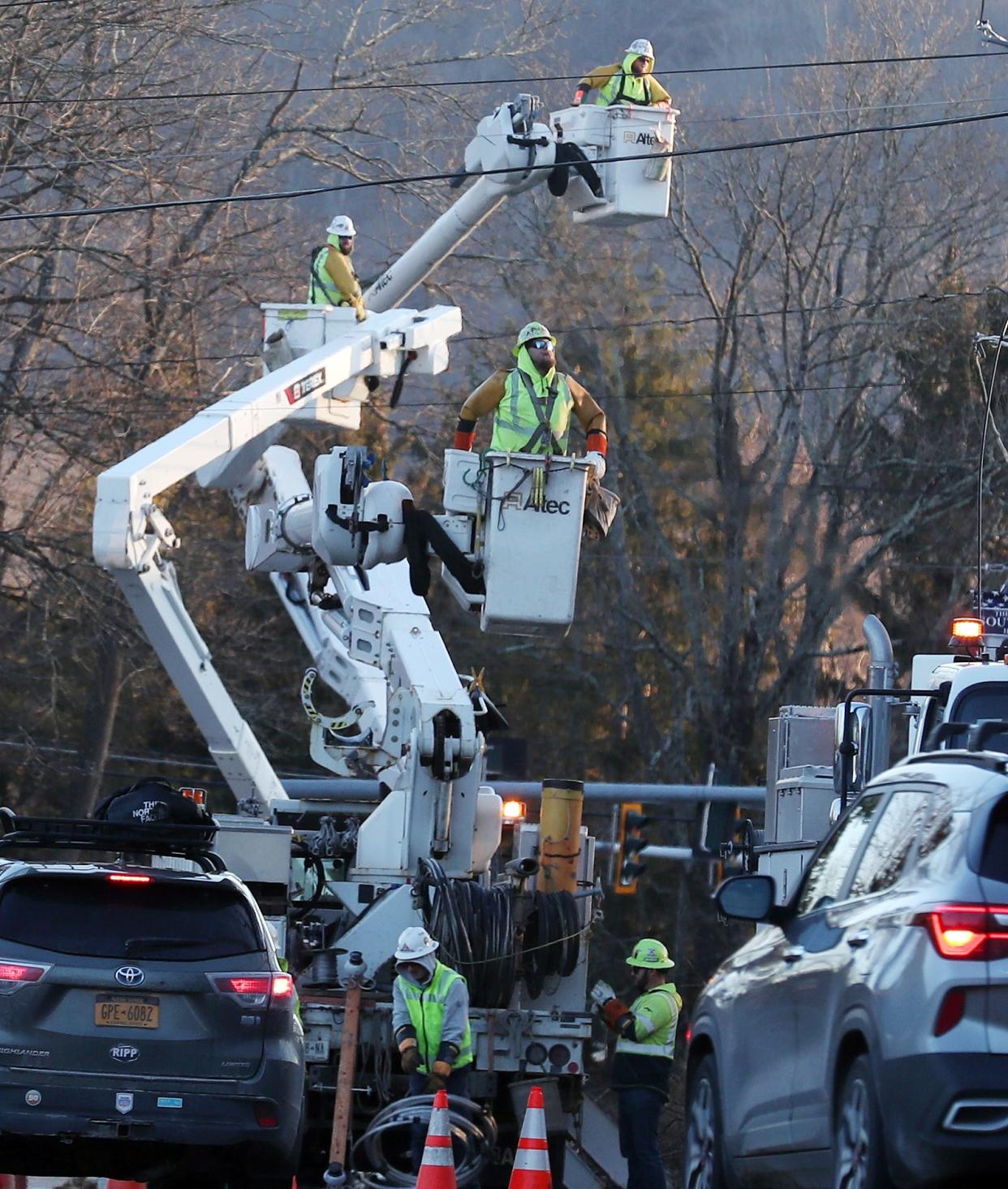 An out of town utility crew works to repair power lines along Route 22 near Milltown Road in the town of Southeast Jan. 14, 2024. High winds in the area caused many trees and power lines to come down over the weekend.