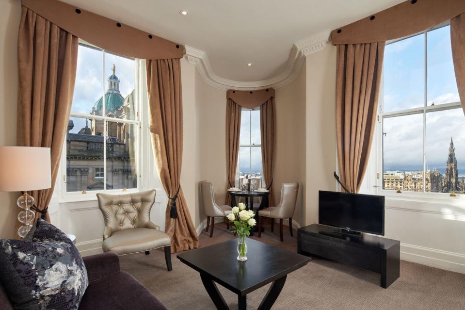 a living room with a large window overlooking the city