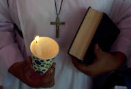 <p>A Pakistani Christian holds candle during a vigil to pay tribute to the victims of Wednesday’s bus attack, in Karachi, Pakistan, May 15, 2015. (AP Photo/Shakil Adil) </p>